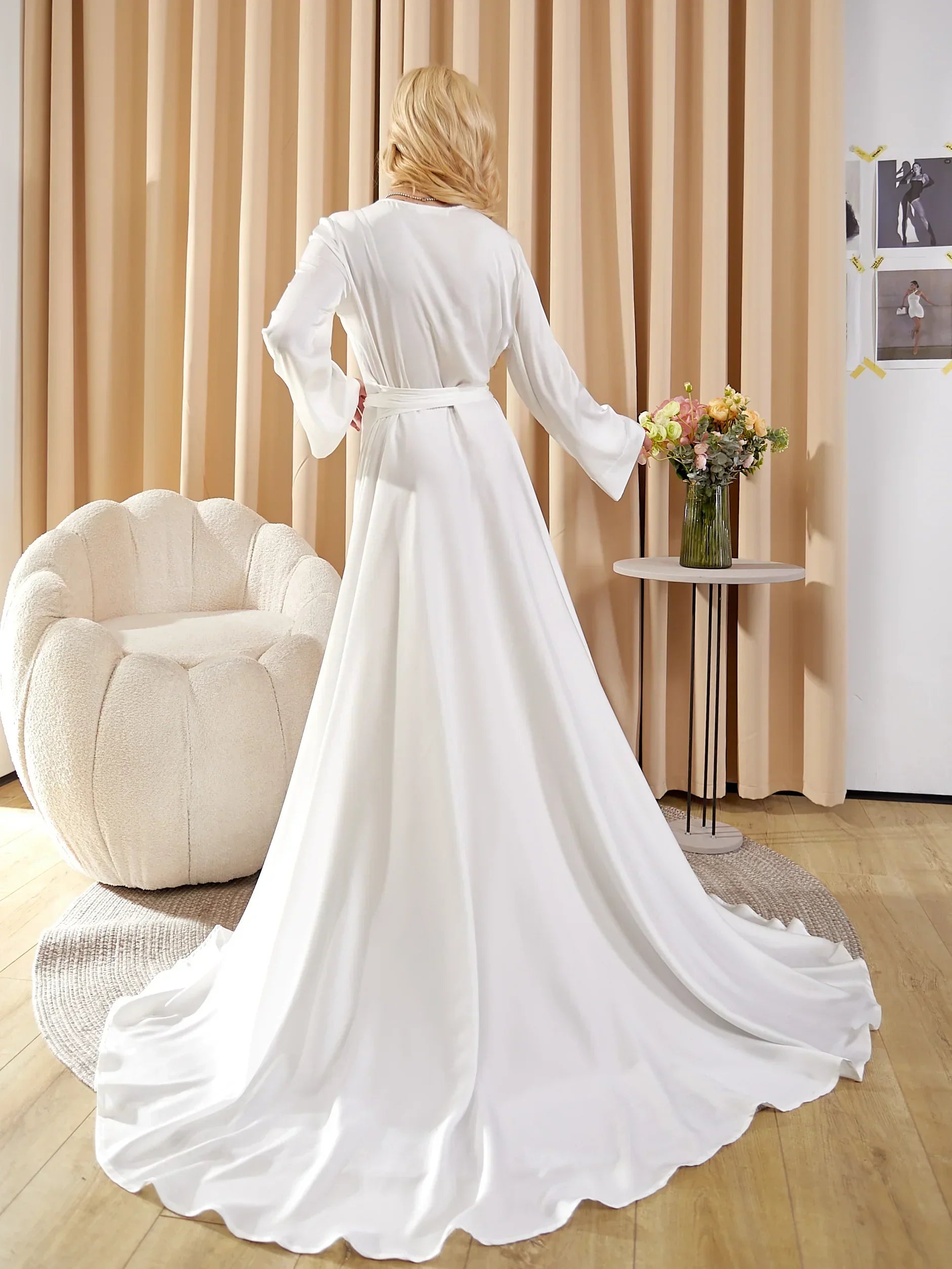 Bride wearing a long white silk bridal robe, perfect for wedding morning photos
