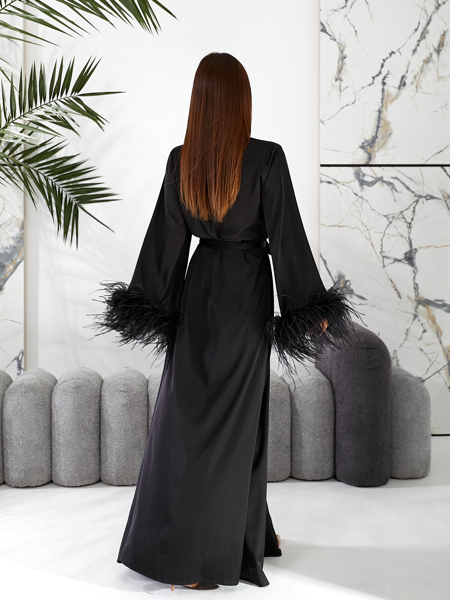 bridal robes, wedding morning robe, wedding gown, bridesmaid gift, long bridal feather robe   Woman wearing a black dress with feathered sleeves in a modern interior setting.