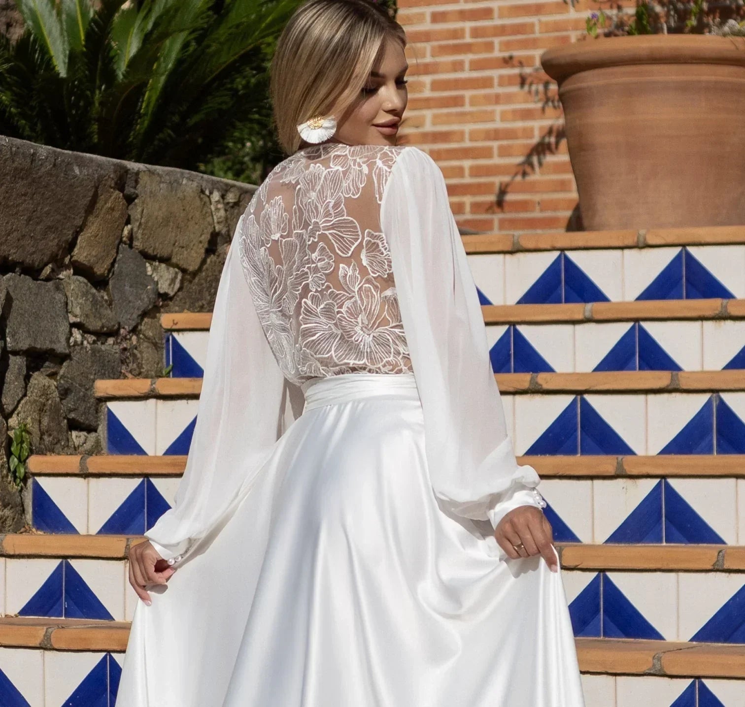 Bride wearing a white sheer lace and silk bridal robe, perfect for wedding morning photos
