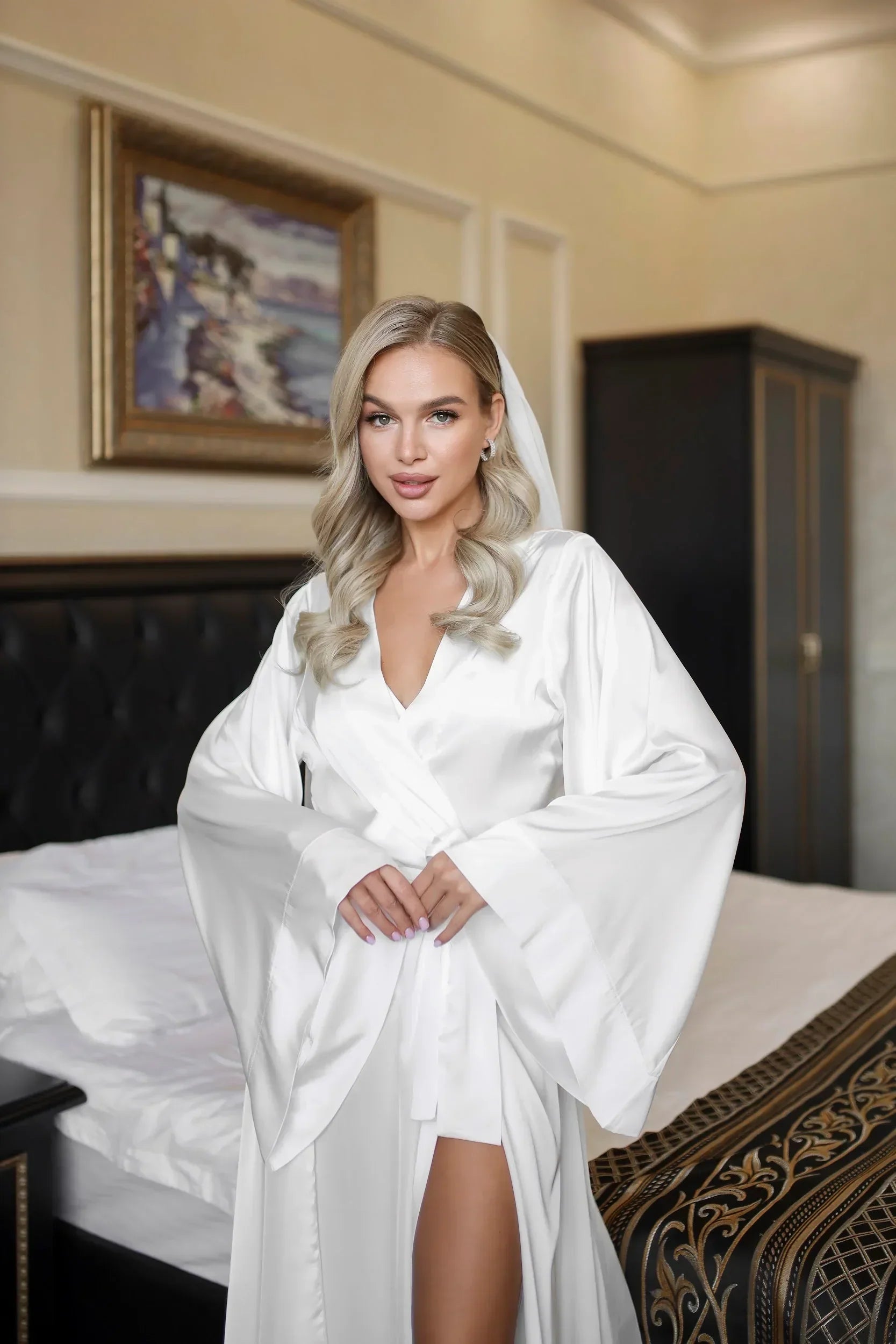 Bride in white silk bridal robe with long sleeves, perfect for wedding morning photoshoot