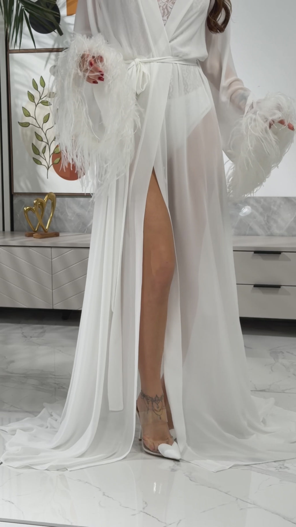 Flowing chiffon train detail on long white bridal robe